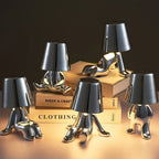 Designer LED Table Lamp Sitting Man with Glossy Finish