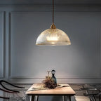 Retro-style glass pendant lamp with an embossed shade and brass finish
