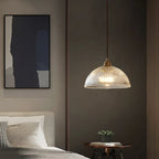 Retro-style glass pendant lamp with an embossed shade and brass finish