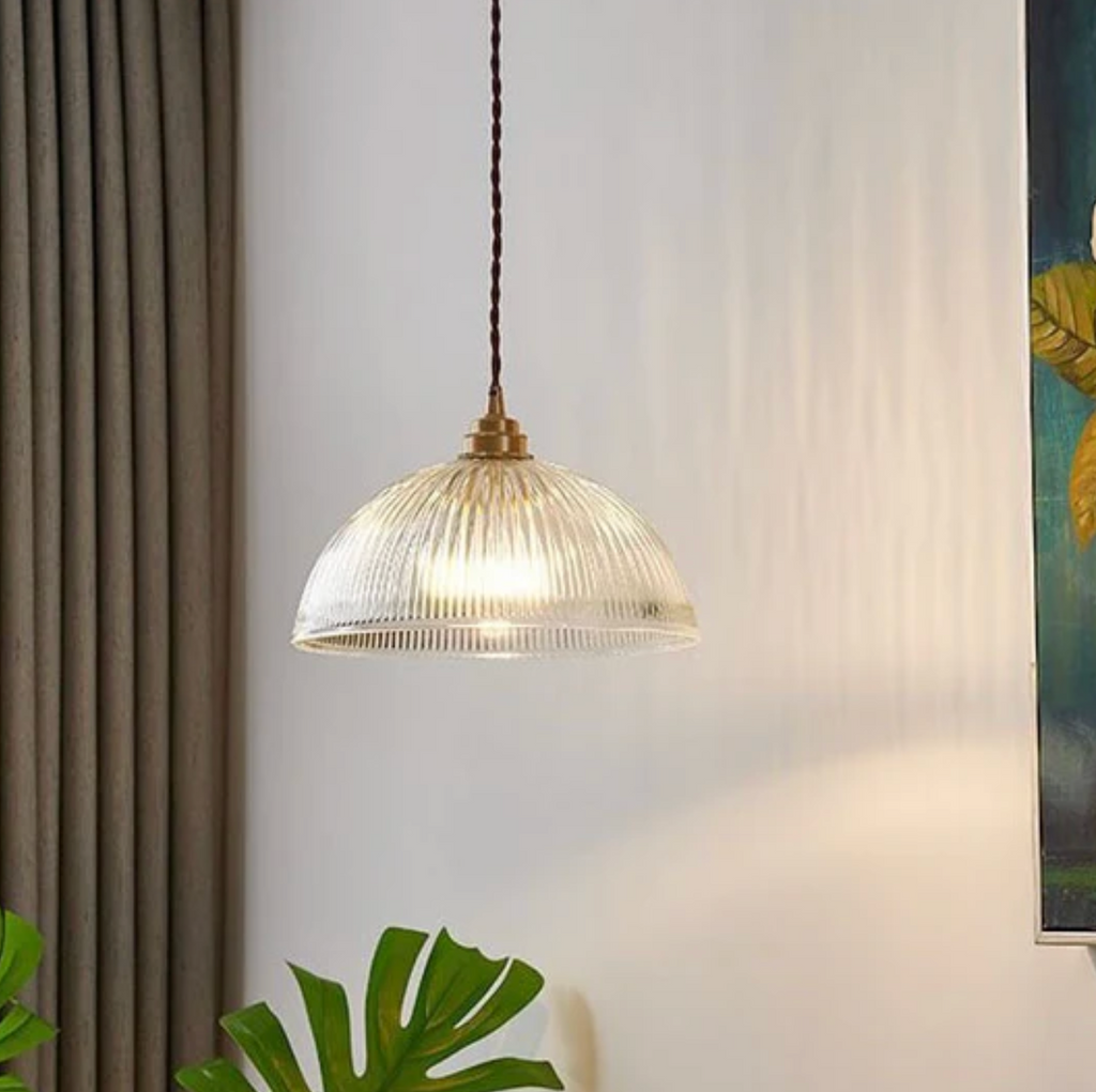 Retro-style glass pendant lamp with an embossed shade and brass finish