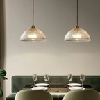 Retro-style glass pendant lamp with an embossed shade and brass finish