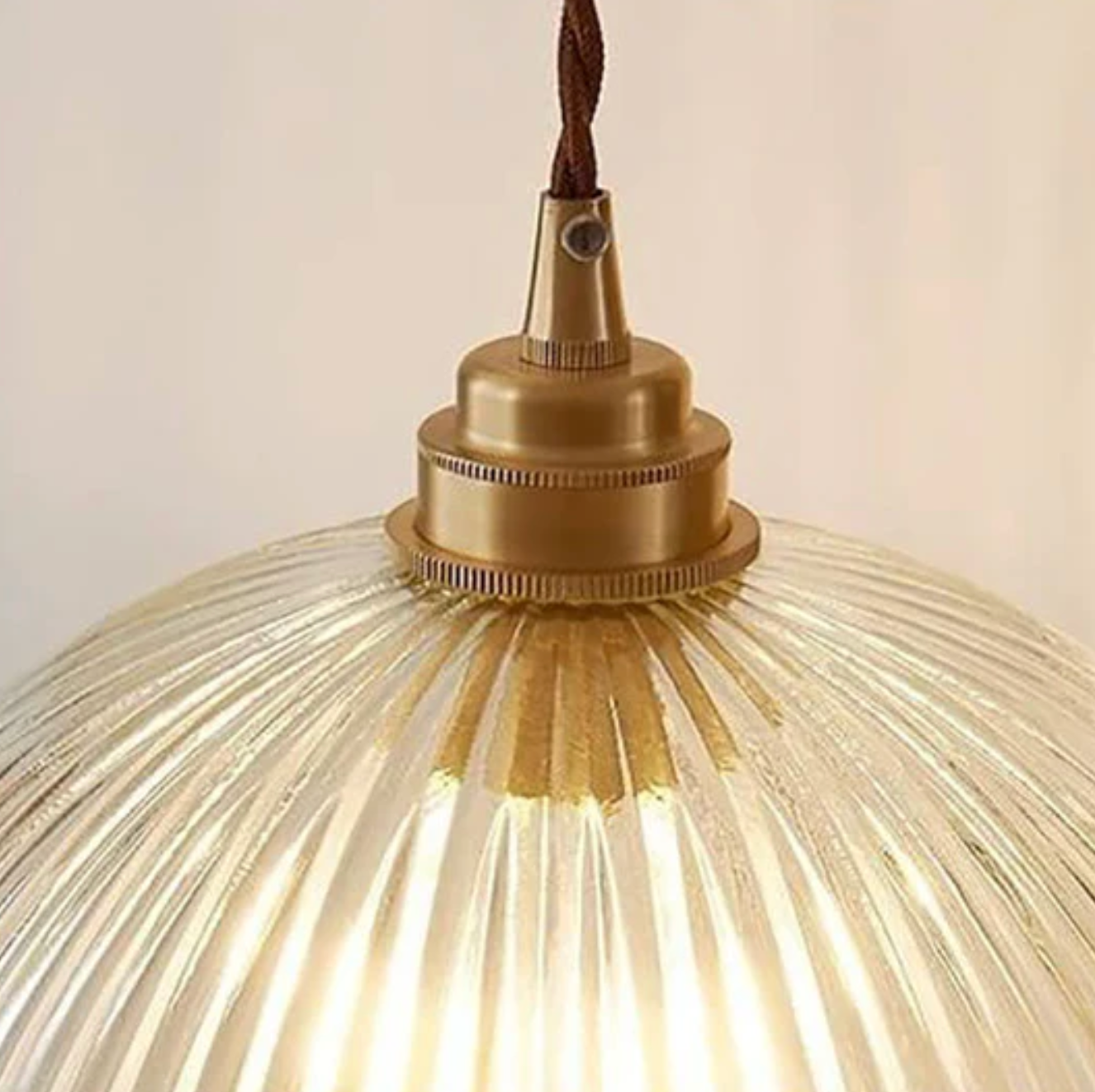 Retro-style glass pendant lamp with an embossed shade and brass finish