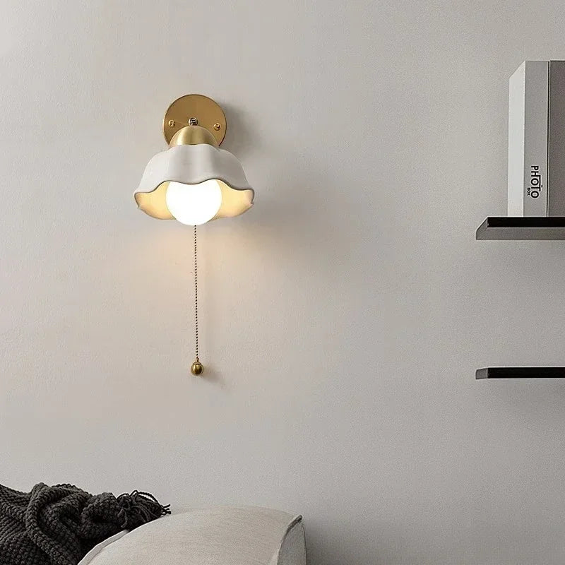 Wall lamp with wavy shade and chain