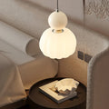 Modern pendant lamp with a spherical decorative element